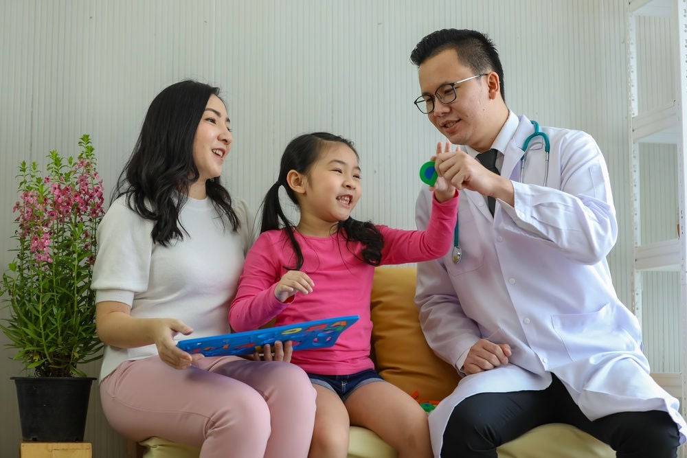 An illustration of a person looking at a giant phone in front of a giant pile of books